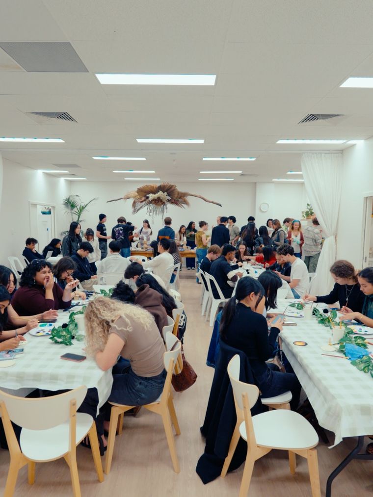 Students at long tables at a club social dinner